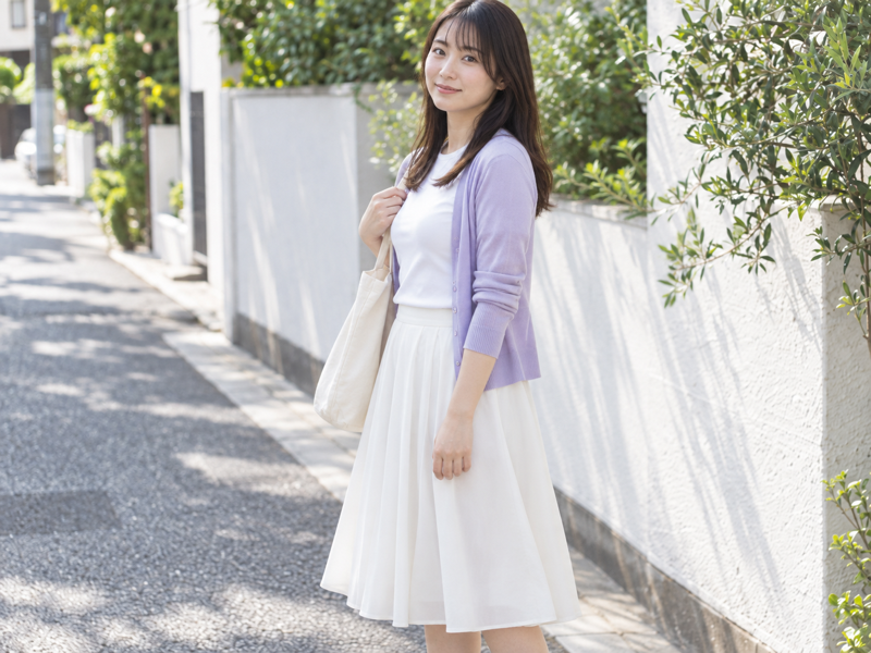 Adult woman in a lavender cardigan on a quiet city street