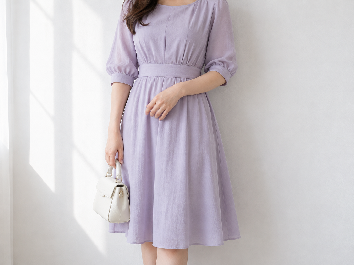 Cropped portrait of an adult woman in a lavender dress with her face outside the frame